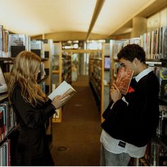 a man and woman reading books in a library