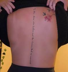 the back of a woman's body with writing on it