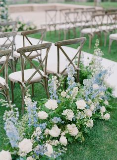 rows of chairs lined up with flowers and greenery