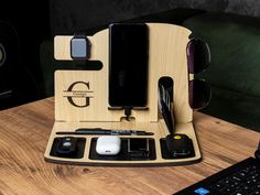 an assortment of electronics sitting on top of a wooden table