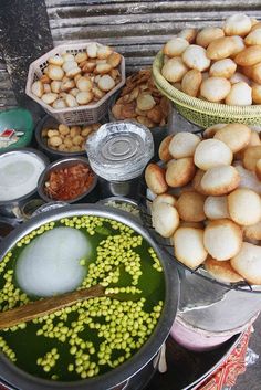 several bowls filled with food sitting on top of a table