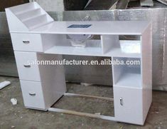 an office desk with drawers and shelves in the middle of a warehouse flooring area