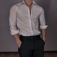 a mannequin wearing a white shirt and black pants with his hands in his pockets