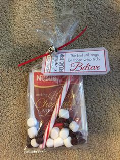 a bag filled with candy and marshmallows on top of a carpeted floor