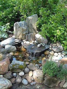 there is a small pond in the middle of some rocks