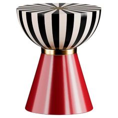 a red vase with black and white stripes on it's top, sitting in front of a white background