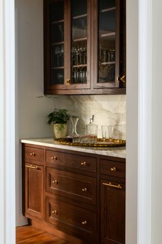 a kitchen with wooden cabinets and marble counter tops