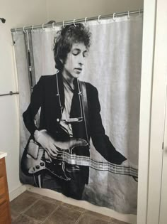 a shower curtain with a photo of a man playing the guitar