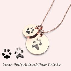 two dog paw prints are shown on the front and back of a necklace that reads, your pet's actual paw prints