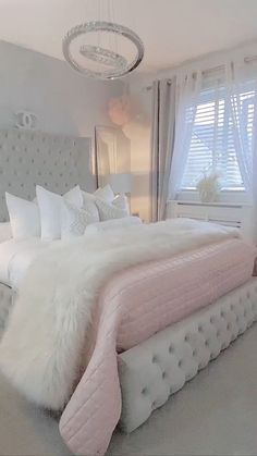 a bedroom with a large bed covered in white fur