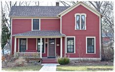 a red house with white trim and windows