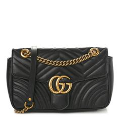 This is an authentic GUCCI Calfskin Matelasse Small GG Marmont Shoulder Bag in Black. This stylish shoulder bagis crafted of chevron-quilted calfskin leather in black. The bag features an aged gold chain-link shoulder strap with a black leather shoulder pad and an aged gold Gucci GG logo on the crossover flap. The bag opens with a concealed press lock to a beige fabric interior with a zipper pocket. Black And Gold Handbag, Gold Handbags, Gg Logo, Stylish Shoulder Bag, Gg Marmont, Beige Fabric, Shoulder Bag Black, Hand Bag, Shoulder Pads