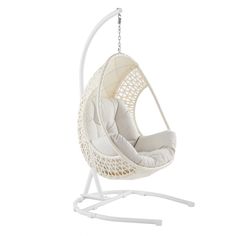 a white swing chair hanging from the ceiling