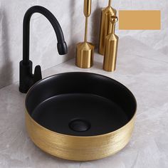 a bathroom sink with black and gold fixtures