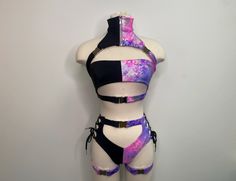 Please send us a message with any questions or if you're needing it by a specific date :) Introducing the Dakota Set, a stunning festival suit that's sure to turn heads wherever you go! This one-of-a-kind rave bodysuit features a unique design with a half black and half purple and pink print, making it a true statement piece. The suit is designed with leg buckles, adding a touch of edginess to the overall look. Made with high-quality materials, the Dakota Set is comfortable to wear and durable e Rave Outfit Pattern, Garter Rave, Goth Rave Outfits, Garter Outfit, Galactic Fashion, Colorful Rave Outfit, Rave Suits, Rave Bodysuit, Gear Design