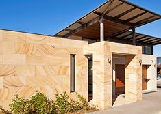 a building made out of wood sitting on the side of a road next to a parking lot