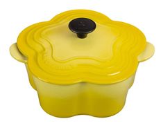 a yellow casserole dish with a black lid