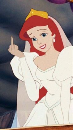 ariel from the little mermaid in her wedding dress and tiara, pointing at something