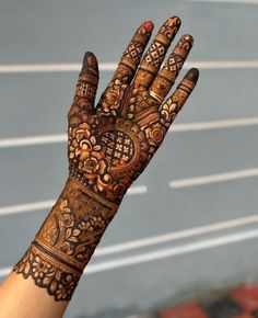 a woman's hand with henna on it