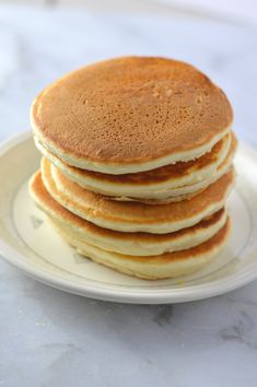 a stack of pancakes sitting on top of a white plate