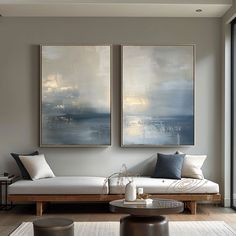 a living room with two paintings on the wall