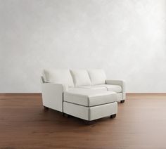 a white couch sitting on top of a wooden floor