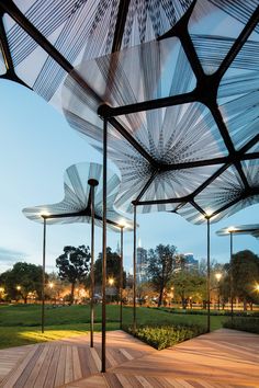 an outdoor dining area with tables and umbrellas over looking the cityscape at dusk