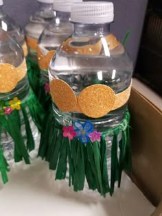 some water bottles with grass and flowers on them