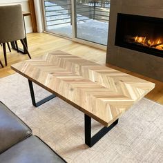 a wooden table sitting in front of a fire place