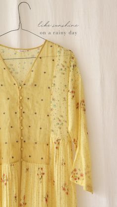 Handcrafted in gossamer Chanderi in a bright shade of yellow, this dress is strewn with our signature garden prints. Subtle waist gathers, v-neck, and an embroidered bodice with dropped sleeves lend it timeless charm. Chanderi Dress, Dandelion Dress, India Design, Simple Kurti Designs, Western Tops, Cotton Slip, Embroidered Bodice, Breezy Dress, Garden Print