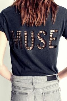 a woman with her back to the camera wearing a t - shirt that says museum