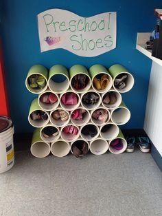 a bunch of cups that are on the floor in a room with a sign above them