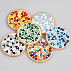 six colorful cookies are arranged in the shape of geometric designs on top of each other