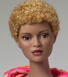 a mannequin head with blonde hair wearing a pink and orange jacket on it