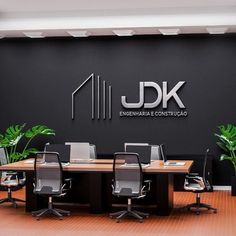 an empty conference room with desks and chairs in front of the j dk logo