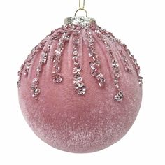 a pink ornament hanging from a gold chain