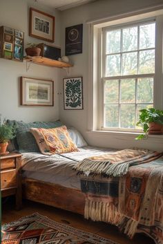 a bed sitting under a window next to a wooden dresser