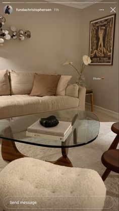 a living room filled with furniture and a glass table