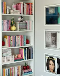 the bookshelf is filled with many different colored books and pictures on it's sides