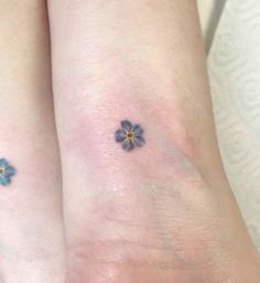 two small blue flowers on the wrist