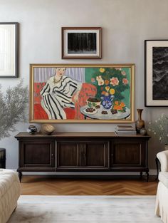 a living room filled with furniture and paintings on the wall