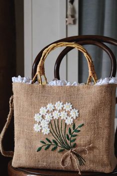 a bag with flowers on it sitting on top of a chair