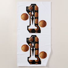 a towel with basketballs on it and the letter e written in large capital letters