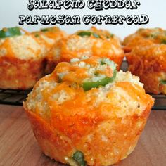 several small muffins with green peppers and cheese in them on a cooling rack