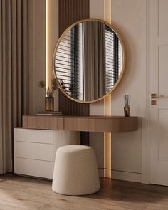 a round mirror sitting on top of a wooden table next to a white stool in front of a window