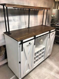 a kitchen island made out of an old barn door with wine racks on the top