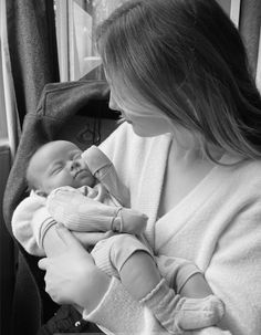 a woman holding a baby in her arms