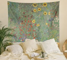 a large tapestry hanging on the wall above a bed