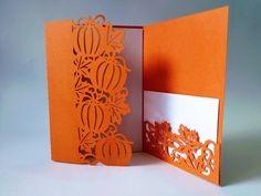 an orange and white card with cut outs