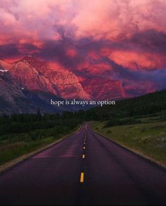 an empty road with the words hope is always an option in front of a mountain range